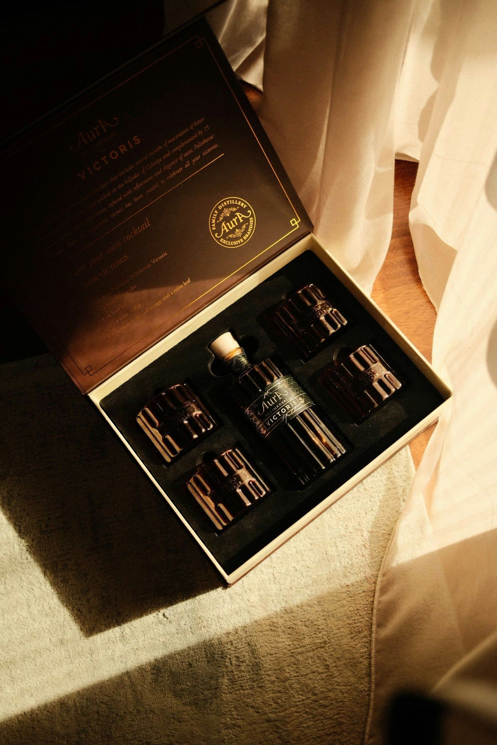 Premium black box with a liquor bottle and glasses for a corporate gift