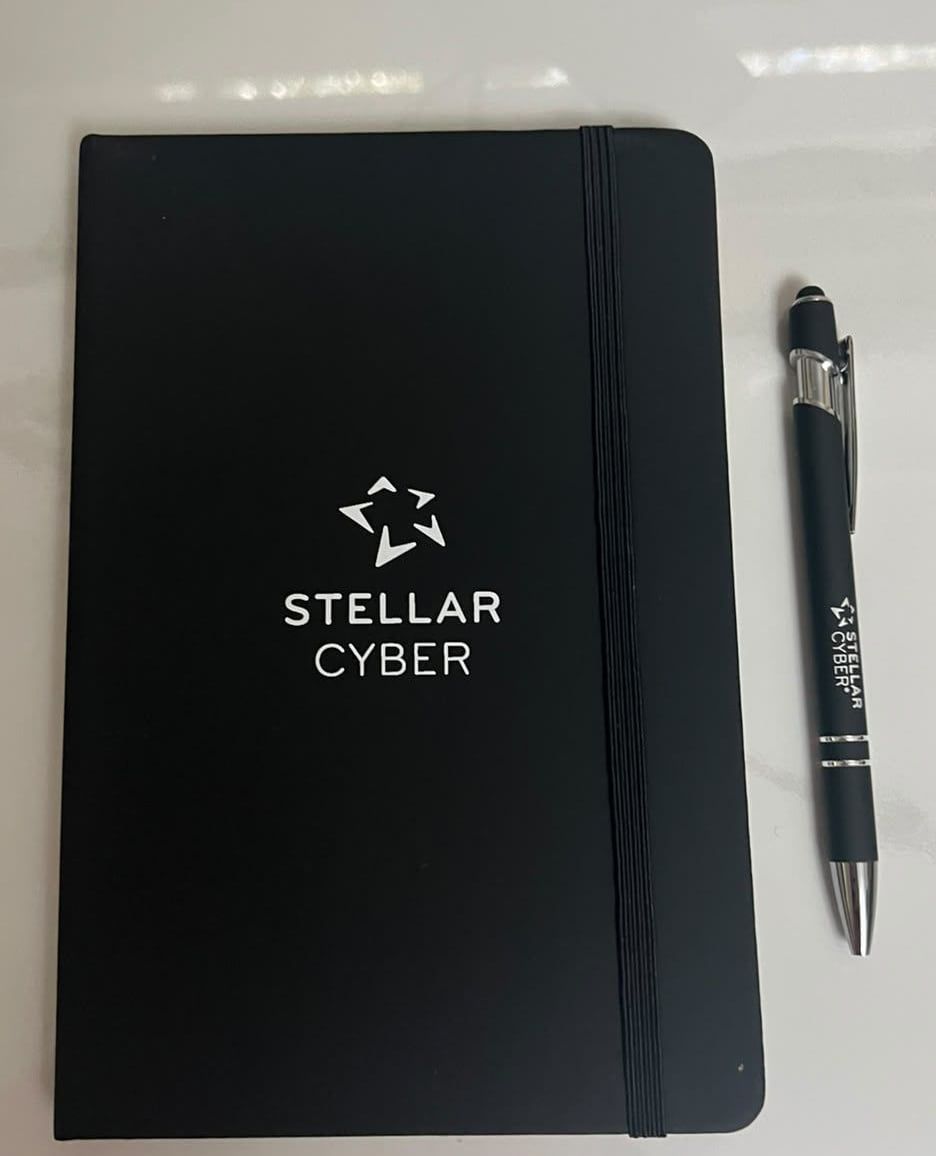 Black notebook and pen with a company logo for an employee kit